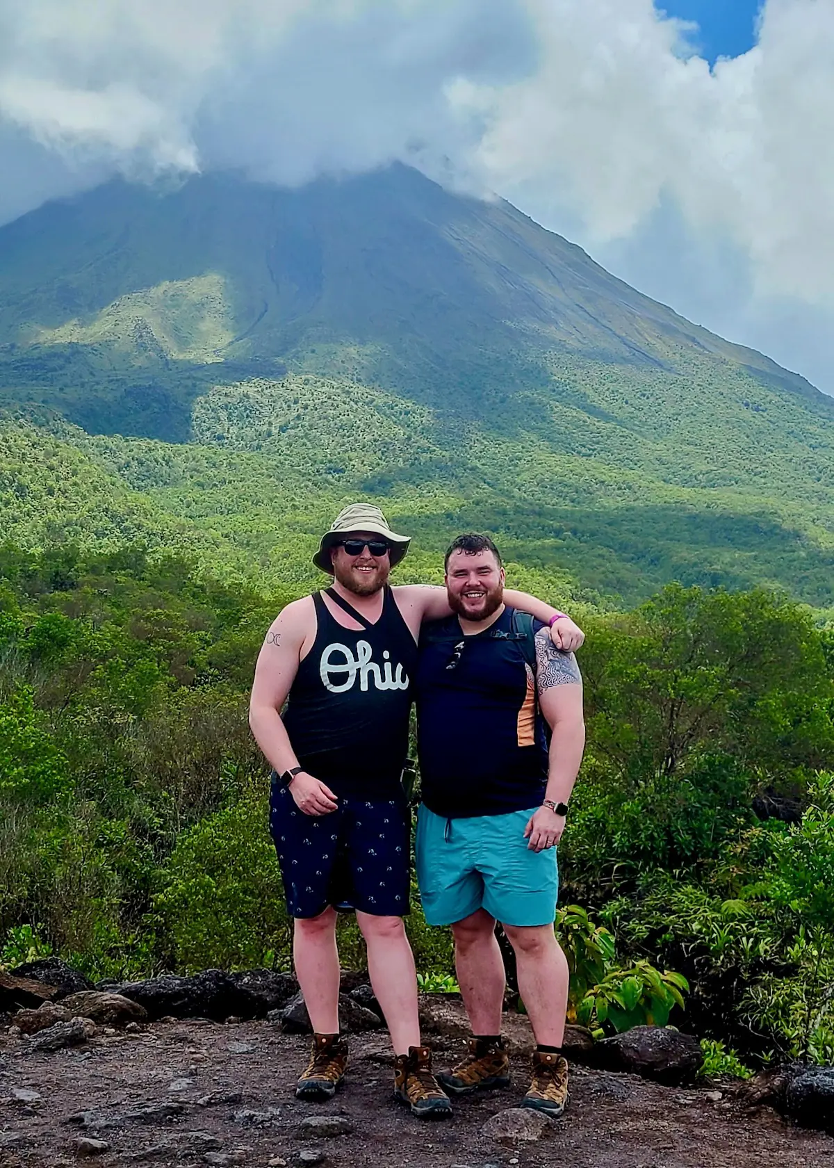 2 gay bears standing in front of Arenal Volcano in Costa Rica.