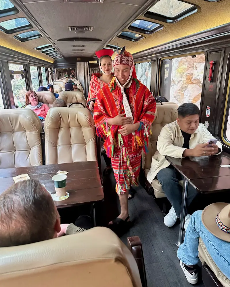 Servers in traditional garb aboard the 360 Machu Picchu train on our gay trip to Peru