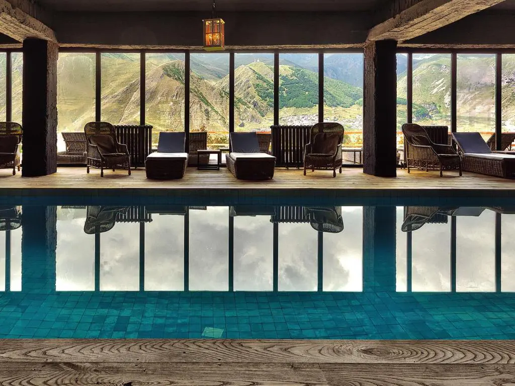 The pool and its mountain views at Rooms Kazbegi, one of our Georgia gay-welcoming hotels.