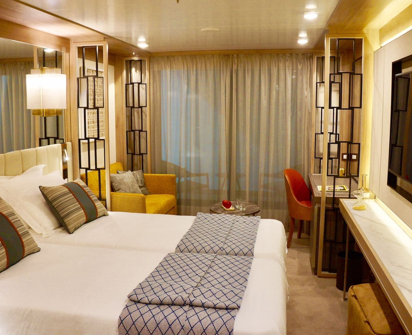 A preview of The World Explorer's Veranda Suite with a twin bed configuration.