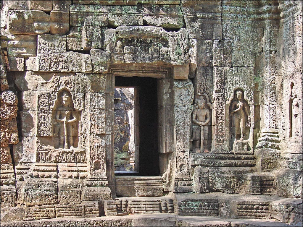 A closeup of an intricate door and the beautiful bas-reliefs at Ta Som.