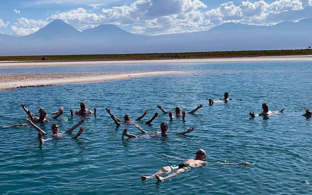 Out Adventures' gay Chile tour guests float in a lagoon in Atacama Desert.