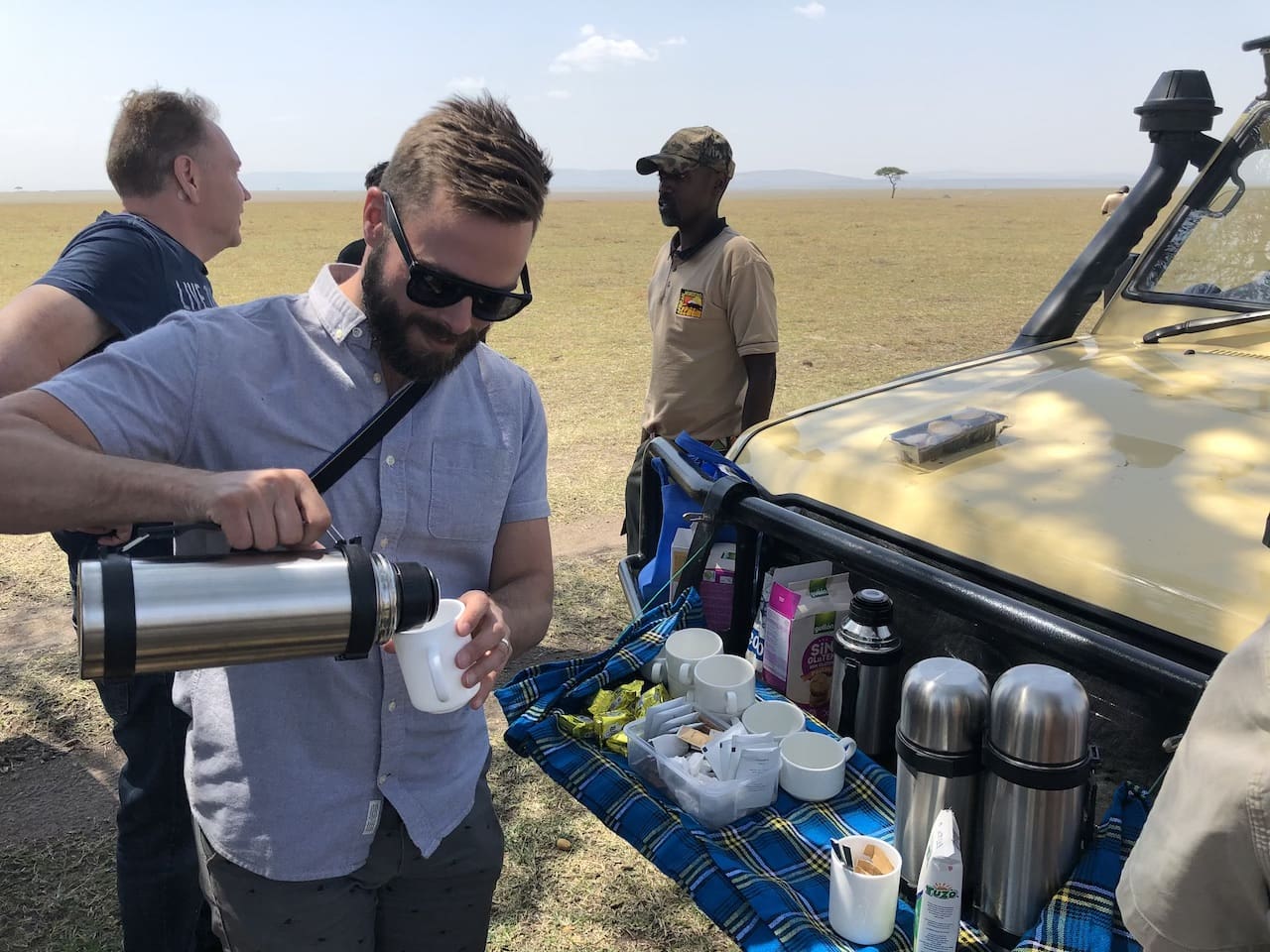 Robert Sharp, Founder of Out Adventures, pours coffee between game drives in Kenya.
