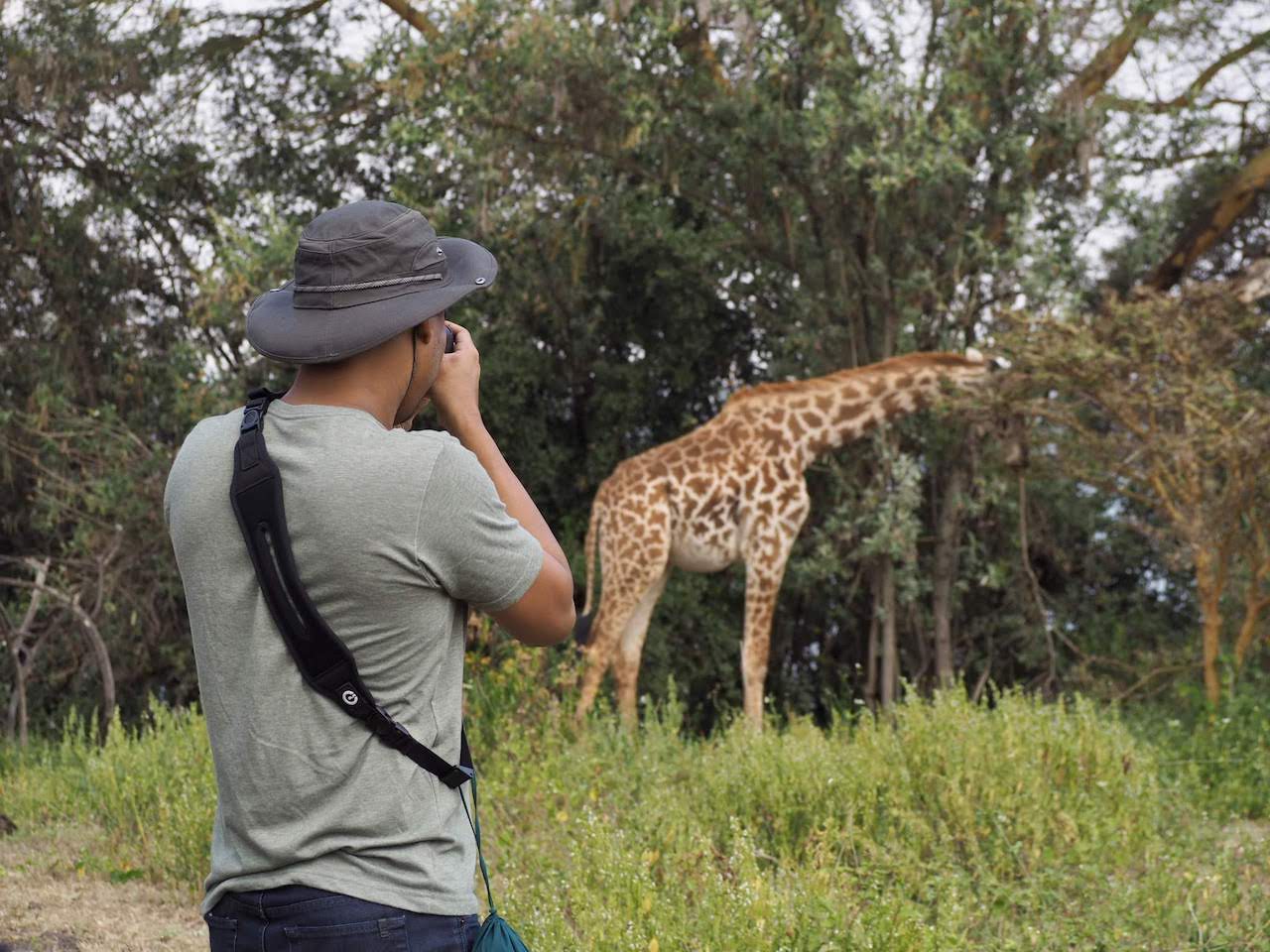 One traveller photographs a giraffe in the distance on Crescent Island.