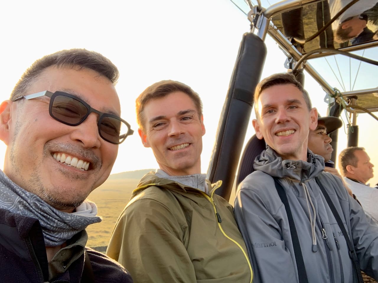 Three gay travellers prepare for a hot air balloon ride in Kenya.