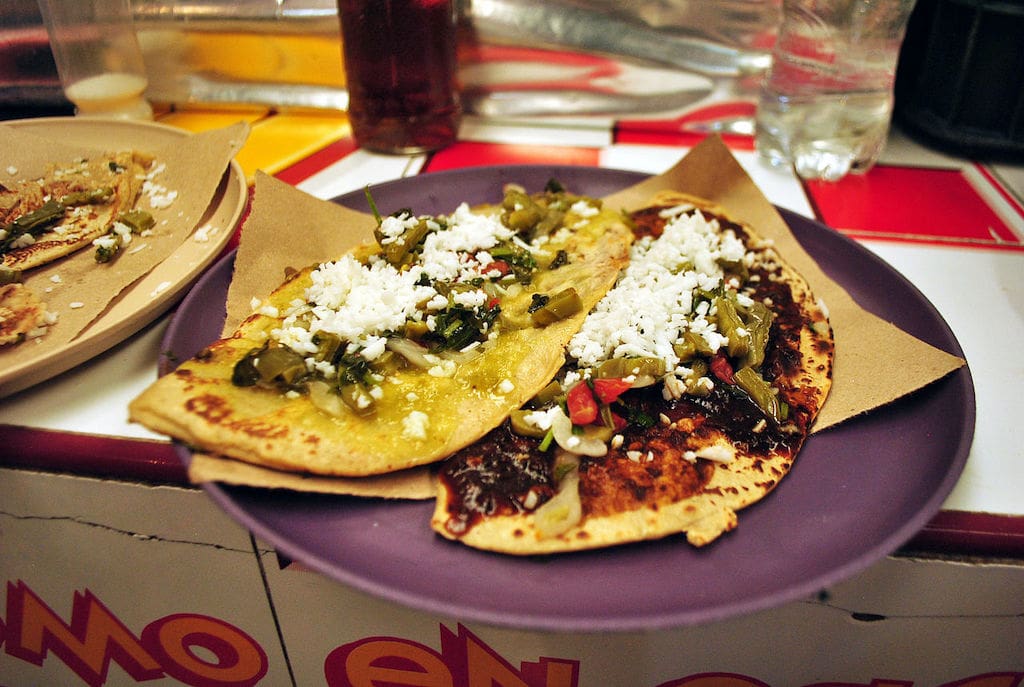 Two tlacoyos with nopales and cheese.
