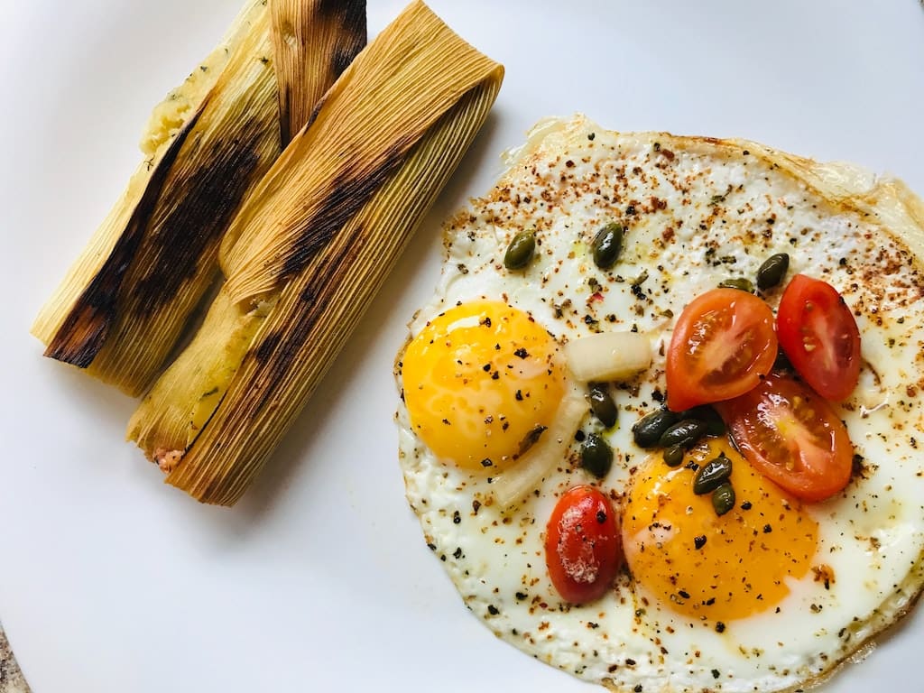 A picture of tamales with eggs.