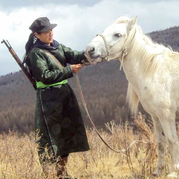 Out Adventures' local gay-welcoming Mongolia guide, Tuul, in the countryside with her horse.