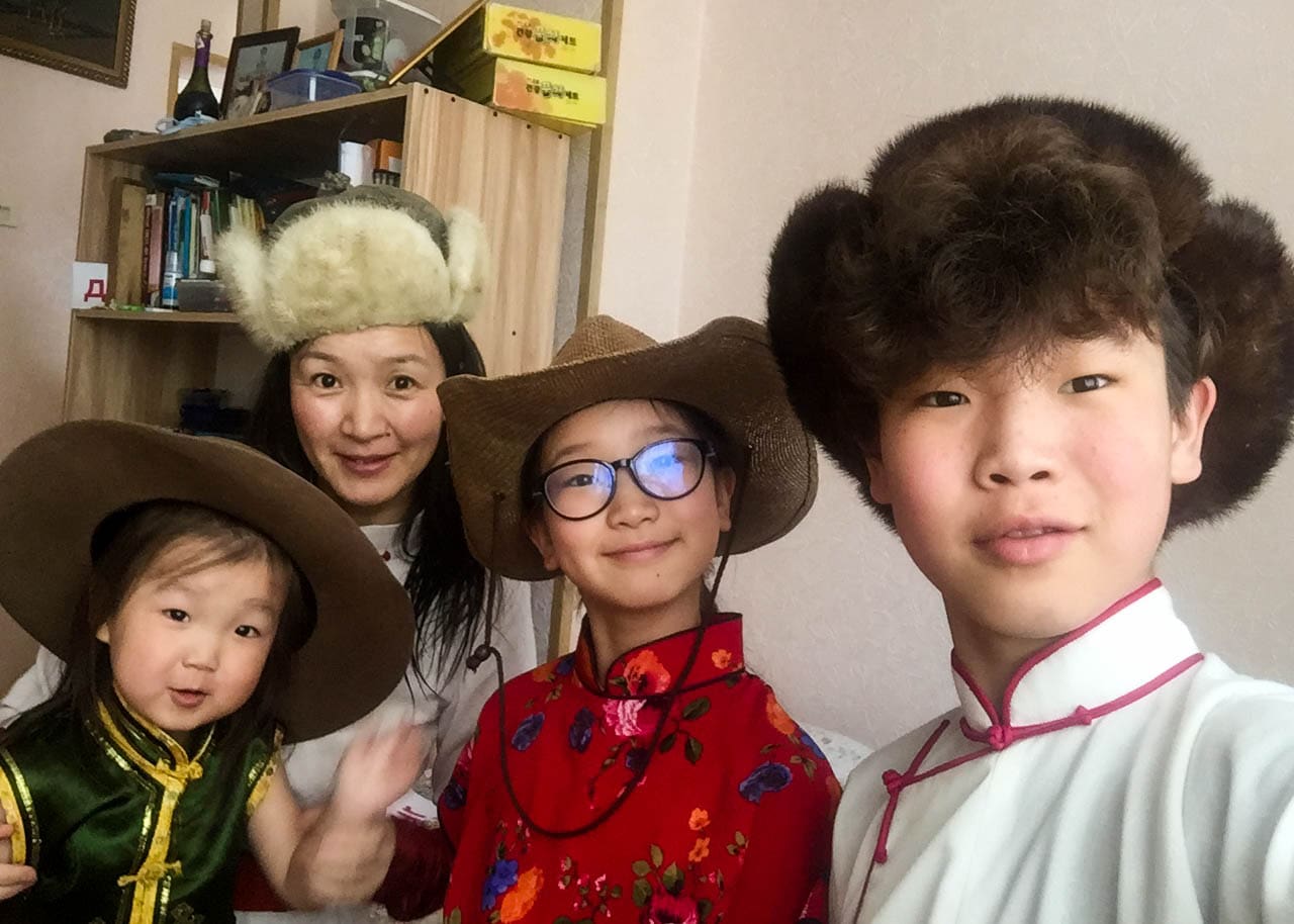 Our local Mongolia guide Tuul with three of her children all wearing different hats.