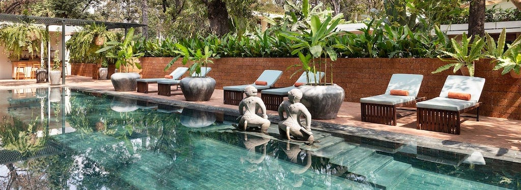 The pool and lounge chairs inside FCC Angkor by AVANI.