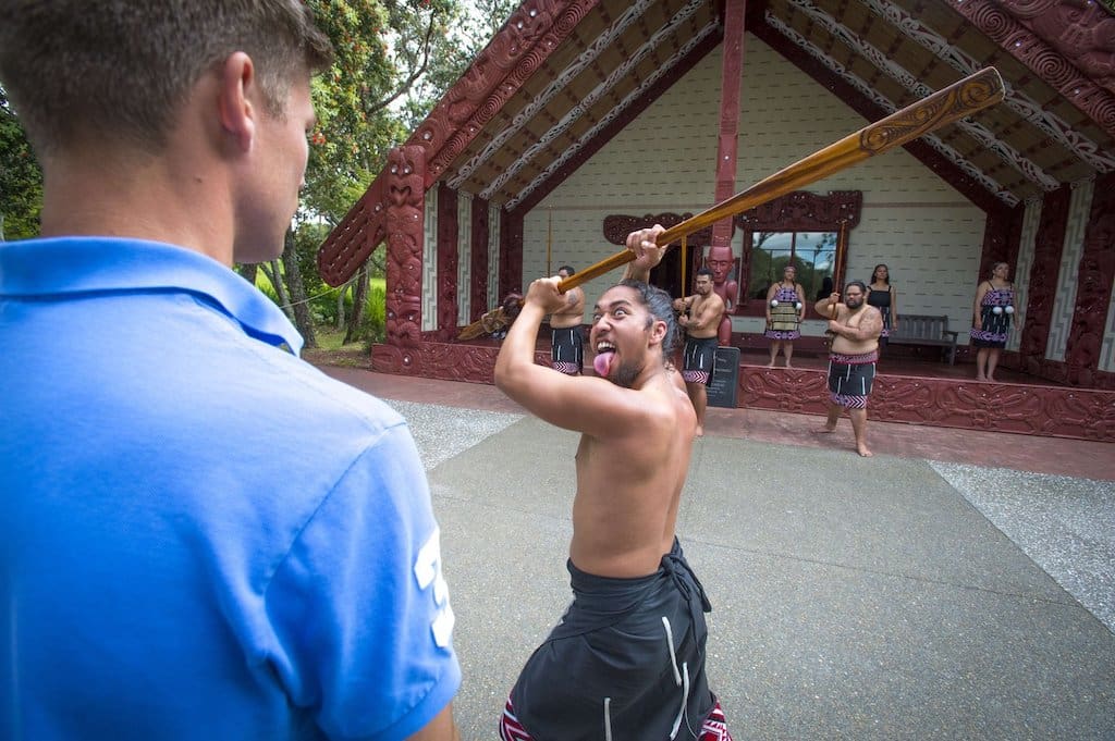 A Maori male performs a Haka dance.